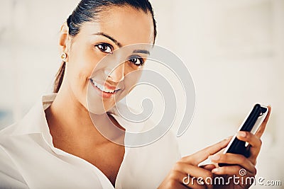 Indian business woman using mobile phone happy