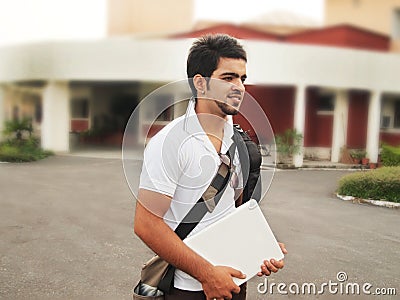 Indian College student holding laptop.