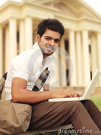 Indian College student working on laptop.