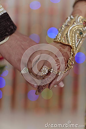 Indian Hindu Bride & Groom holding hands