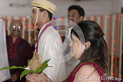 Indian Hindu Groom s sister looking at groom at the ritual of exchanging garland in maharashtra wedding.