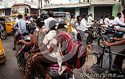 Indian riders ride motorbikes on busy road