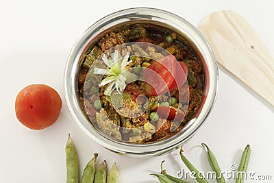 Indian vegetarian dish Mix vegetable in steel pot with raw vegetables.