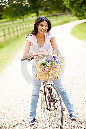 Indian Woman On Cycle Ride In Countryside