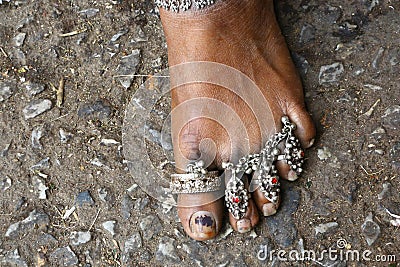 Indian woman foot adorned with silver jewels