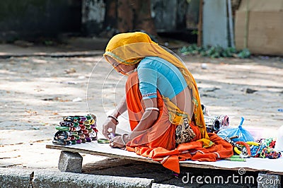 Indian woman iin colorful sari sells souvenirs