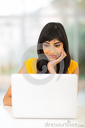 Indian woman looking computer