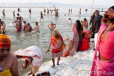 Indian woman in sari collect holy water