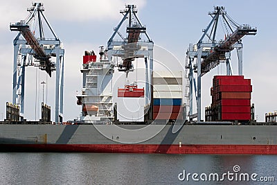 Industrial cranes load a container ship