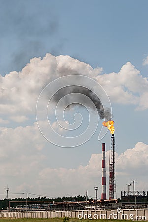 Industrial landscape with a burning torch