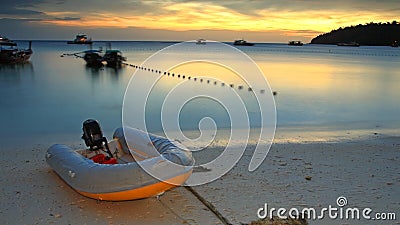 Inflatable boat on beach at twilight