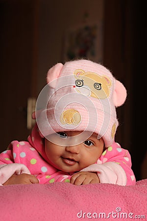 Innocent asian baby girl in pink winter cap