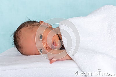 Innocent baby under towel