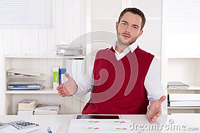 Inquiringly clerk with open hands at desk.