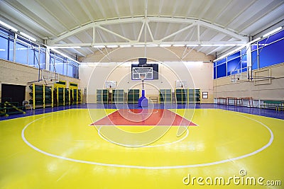 Inside school gym hall with red-yellow floor