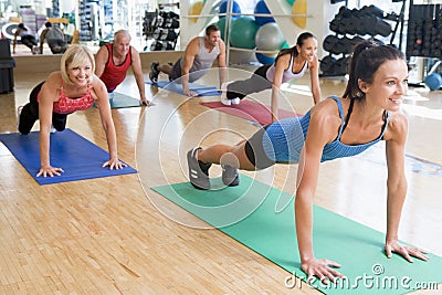 Instructor Taking Exercise Class At Gym