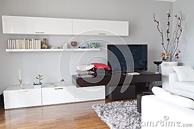 Interior of a living room, flat tv white furniture