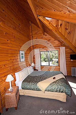 Interior of mountain wooden lodge double bedroom