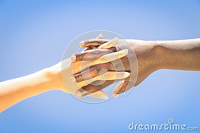 Interracial human hands crossing fingers for friendship and love