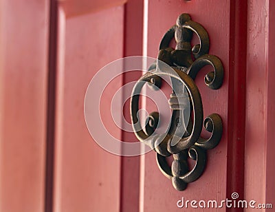 Iron cast door knocker on red door