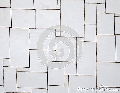 Irregular white tiles on a wall