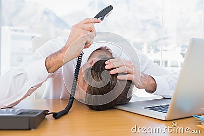 Royalty Free Stock Photos: Irritated businessman holding the phone