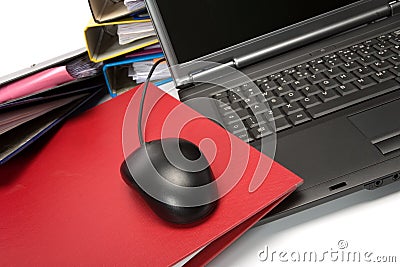 Isolated stack of folders with laptop computer