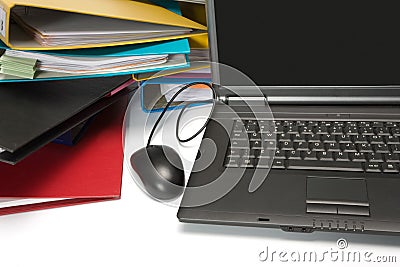 Isolated stack of folders with laptop computer