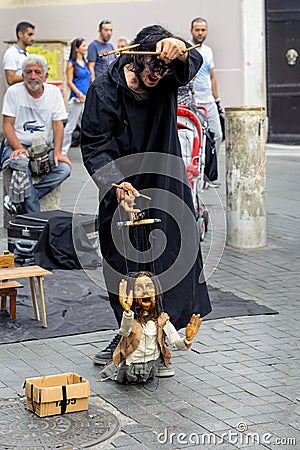 Istanbul, Turkey - September 07, 2014: Puppeteer Nehir Giritli working in the Kadikoy bazaar square Istanbul.