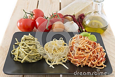 Italian flag made with pasta and ingredients on wood background