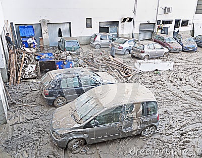 Italian floods aftermath and cleanup, damaged cars