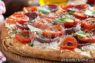 Italian food - pizza with salami and tomatoes, selective focus