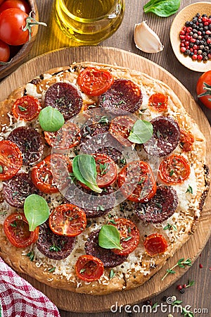 Italian food - pizza with salami and tomatoes, top view
