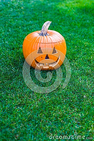 Jack-o-lantern on green grass