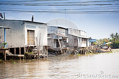 JAN 28 2014 - MY THO, VIETNAM - Houses by a river, on JAN 28, 2