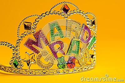 Jeweled Mardi Gras crown on a yellow background