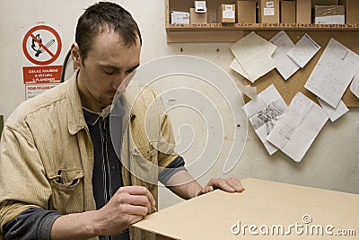 Joiner making furniture in his workshop