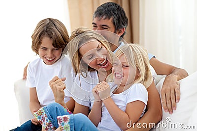 Joyful caucasian family sitting in the living room
