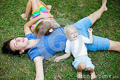 Joyful family enjoying themselves laying on the grass