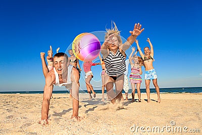 Joyful people playing volleyball