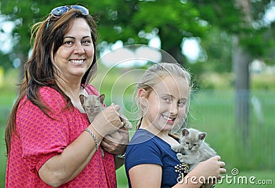 Joyful smiling mom & daughter & new pet kittens