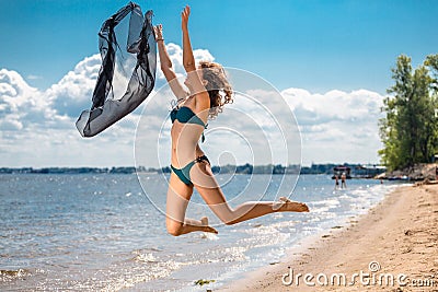Jumping happy girl on the beach, fit sporty healthy sexy body in bikini
