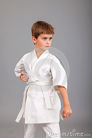 Karate boy in white kimono fighting