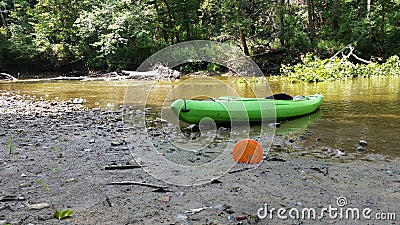 A Kayak and Disc Golf Disc on a River