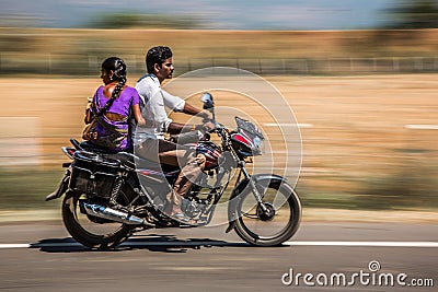 KERALA, INDIA - FEBRUARY 17: Young family riding on a bike