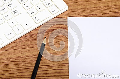 Keyboard computee white paper and black pencil