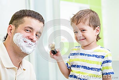 Kid boy and father having fun in bathroom