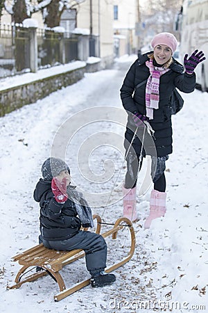 Kid and his mother waving hello