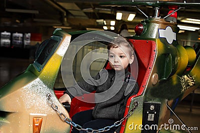 Kid on toy helicopter