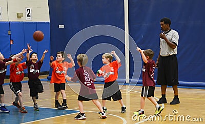 Kids playing basketball match